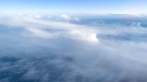 Aerial view of clouds and sky from plane window in daylight Stock-Footage 121354811
