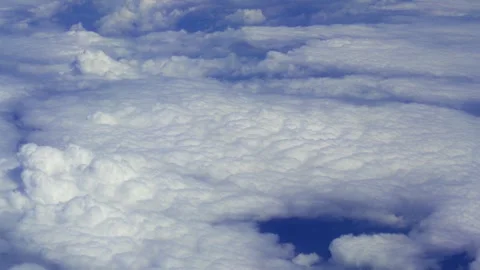 Aerial View of Clouds and Sky from Airplane Window during Plane Travel Stock Footage 333393169
