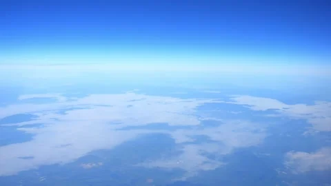 Aerial view of clouds and terrain from high altitude in slow motion 60fps Stock Footage 290097327