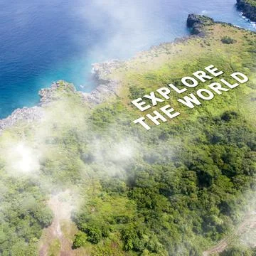 Aerial view of the clouds and the text Explore The World with a lush tropic.. Stock Photos