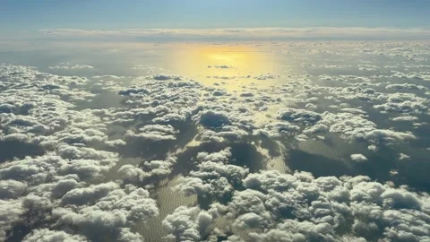 Aerial view of clouds drifting by across the sea and during sunset Stock Footage 261166680