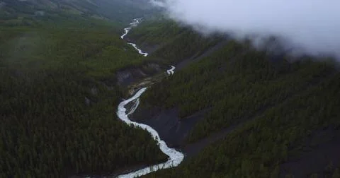 Aerial view of Clouds Drifting Over Majestic Mountains Stock-Fotos