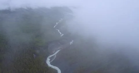 Aerial view of Clouds Drifting Over Majestic Mountains Stock Photos