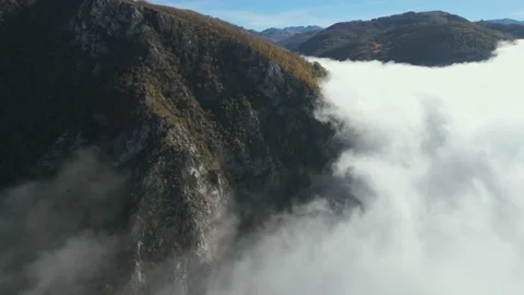Aerial view clouds float in the mountains. Stock Footage 232272965