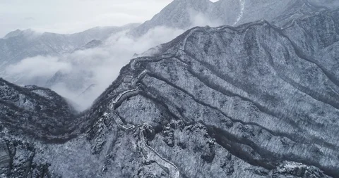 Aerial view of clouds fly over the Great Wall in snow in  China Stock Footage 92419205