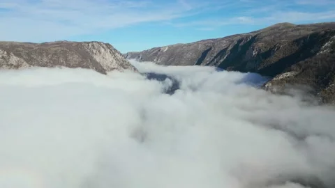 Aerial view, clouds in mountain canyon. Video stock 232272987