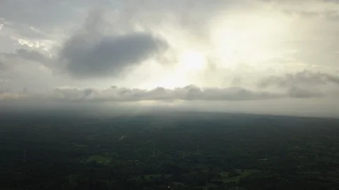 Aerial view of clouds moving in front of the sun over a vast Myanmar landscape Stock-Footage 95672347
