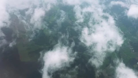 Aerial View of Clouds Moving Over Earth from Airplane Window while Flight Stock Footage 342785192