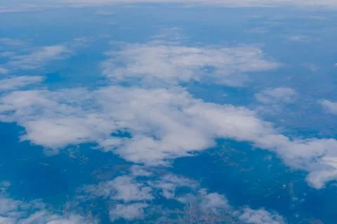 Aerial view of clouds over blue sky and land Stock Photos