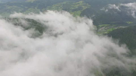 Aerial view of clouds over a mountain forest Stock Footage 67230427