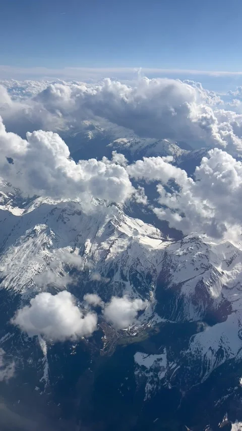 Aerial view of clouds over snowy mountains Stock Footage 334444079