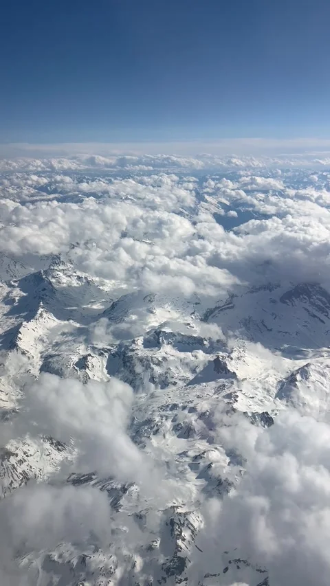 Aerial view of clouds over snowy mountains Stock Footage 334444188