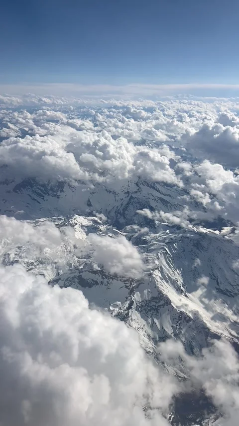 Aerial view of clouds over snowy mountains Stock Footage 334444265