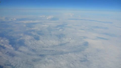 Aerial view of clouds over a vast landscape taken from an airplane window i.. 스톡 동영상 292069501
