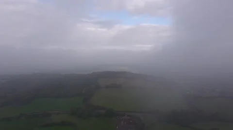 Aerial view of clouds passing through the English countryside. 스톡 동영상 68695142