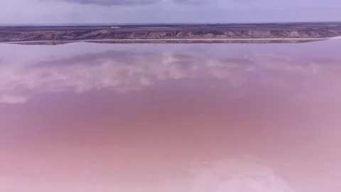 Aerial view of clouds reflected in pink water of salt lake of Kuialnyk estuary, Vídeos de archivo 195933832