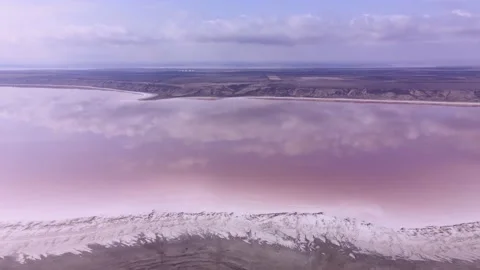 Aerial view of clouds reflected in pink water of Kuialnyk estuary, shore is Stock Footage 195933925