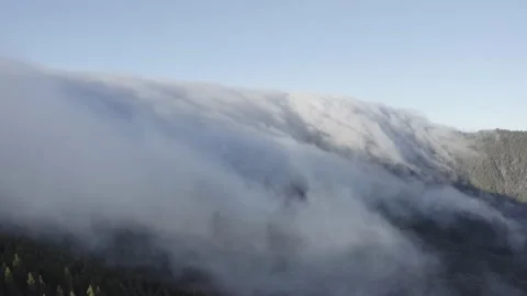 Aerial view. Clouds sea falling down from the mountain to valley-3. Drone. Stock Footage 158557111