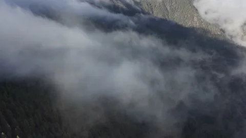 Aerial view. Clouds sea falling down from the mountain to valley-2. Drone shot. Stock Footage 158557120