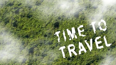 Aerial view of the clouds with text Time to Travel on a lush tropical lands.. Foto stock