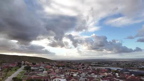 Aerial view of cloudscape seen over neighborhood Stock Footage 254460849