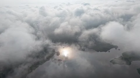 Aerial view of cloudy sky with water reflections over natural landscape Stock-Footage 339858598