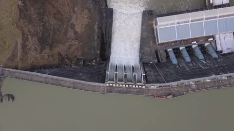 Aerial view of Clyde Dam spill gates releasing water on the Clutha River, New Stock Footage 346451319