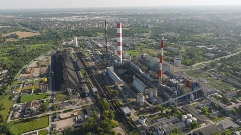 Aerial view of a coal fired power plant and city skyline Stock Footage 346092676