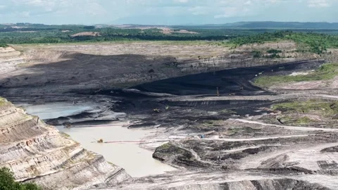 An aerial view of a coal mine featuring a very deep excavation and various .. Stock Footage 343250313