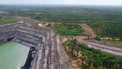 An aerial view of a coal mine pit filled with water due to rain and coal Stock Footage 328970846