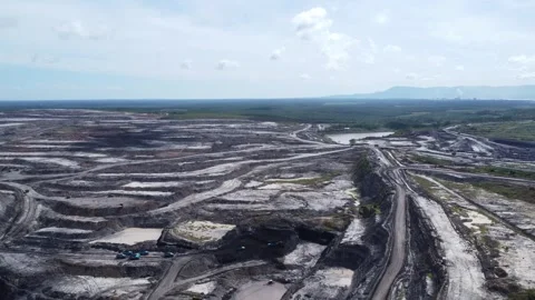Aerial view of coal mining activities and transport trucks passing back and.. Stock Footage 328711617