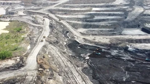 Aerial view of coal mining activities and transport trucks passing back and.. Stock Footage 328711728