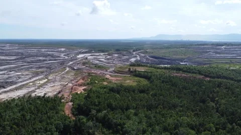 Aerial view of coal mining activities and transport trucks passing back and.. Stock Footage 328711887