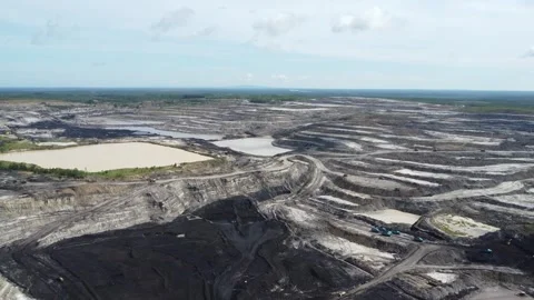 Aerial view of coal mining activities and transport trucks passing back and.. Stock Footage 328712016