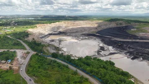 Aerial view of a coal mining site right next to a highway with deep excavat.. Video stock 342478010