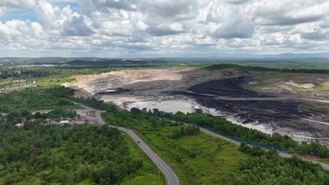Aerial view of a coal mining site right next to a highway with deep excavat.. Video stock 342478074