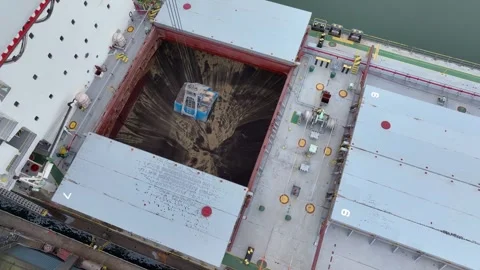 Aerial view of a coal ship being unloaded by cranes in a port Stock Footage 310368022