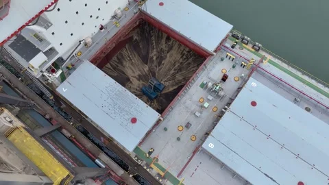 Aerial view of a coal ship being unloaded by cranes in a port Stock Footage 310726791