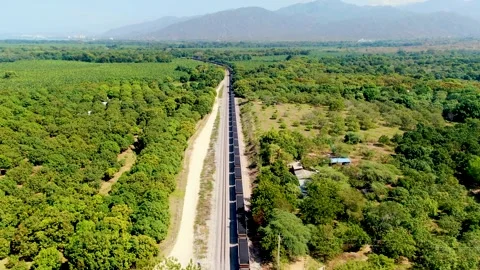 Aerial View Of Coal Transport Train Passing By Termales El Volcan In Ciénaga Stock Footage 332770747