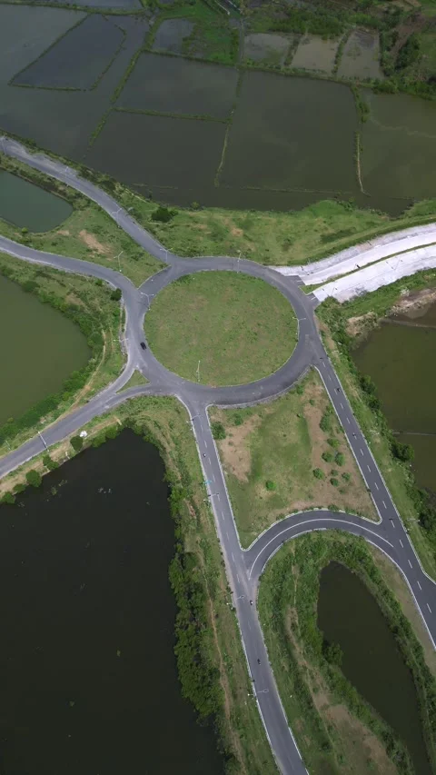 Aerial View Of Coastal Causeway Navigating Salt Flats And Pond Networks Vídeo Stock 334337514