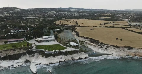 Aerial view of coastal cliffs and fields with buildings, Cyprus. Stock Footage 312838088