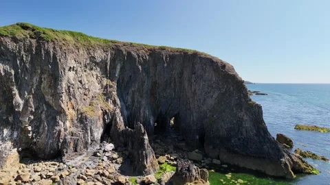 Aerial View of Coastal Cliffs and Sea Arch in 4K Stock Footage 332943130