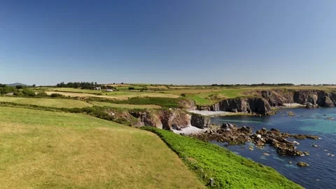 Aerial View of Coastal Cliffs and Green Fields in 4K Stock-Footage 332943146