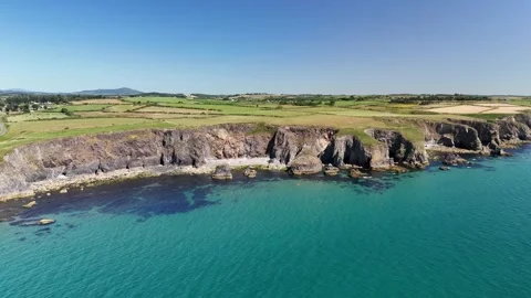 Aerial View of Coastal Cliffs and Turquoise Water in 4K Stock-Footage 332943591
