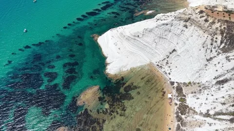 Aerial view of coastal cliffs with white rock formations, sandy beach Stock Footage 345149138