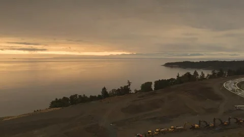 Aerial view of coastal construction site overlooking the ocean at sunset Stock Footage 342198741