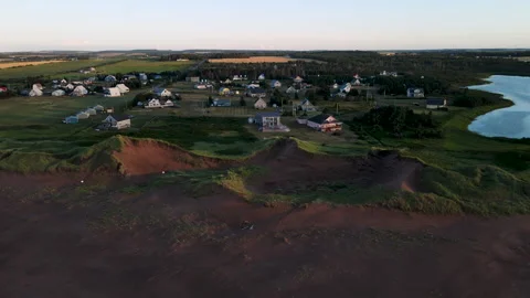 Aerial view of coastal dunes and cottage village on Prince Edward Island Vidéo 340512331
