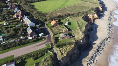 Aerial view of coastal erosion at Happisburgh, England, 4K Video stock 234797553