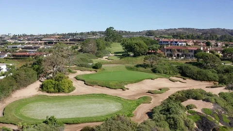 Aerial view coastal golf course with players teeing off on the fairway. Stock Footage 98068340