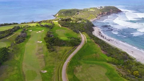 Aerial View of Coastal Golf Course Fairway and Ocean Cliffs Stock Footage 345710370